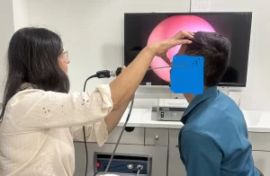 Dr. Archana Jhawar performing a diagnostic nasal endoscopy to evaluate a patient for structural sinus issues in Vashi, Navi Mumbai.